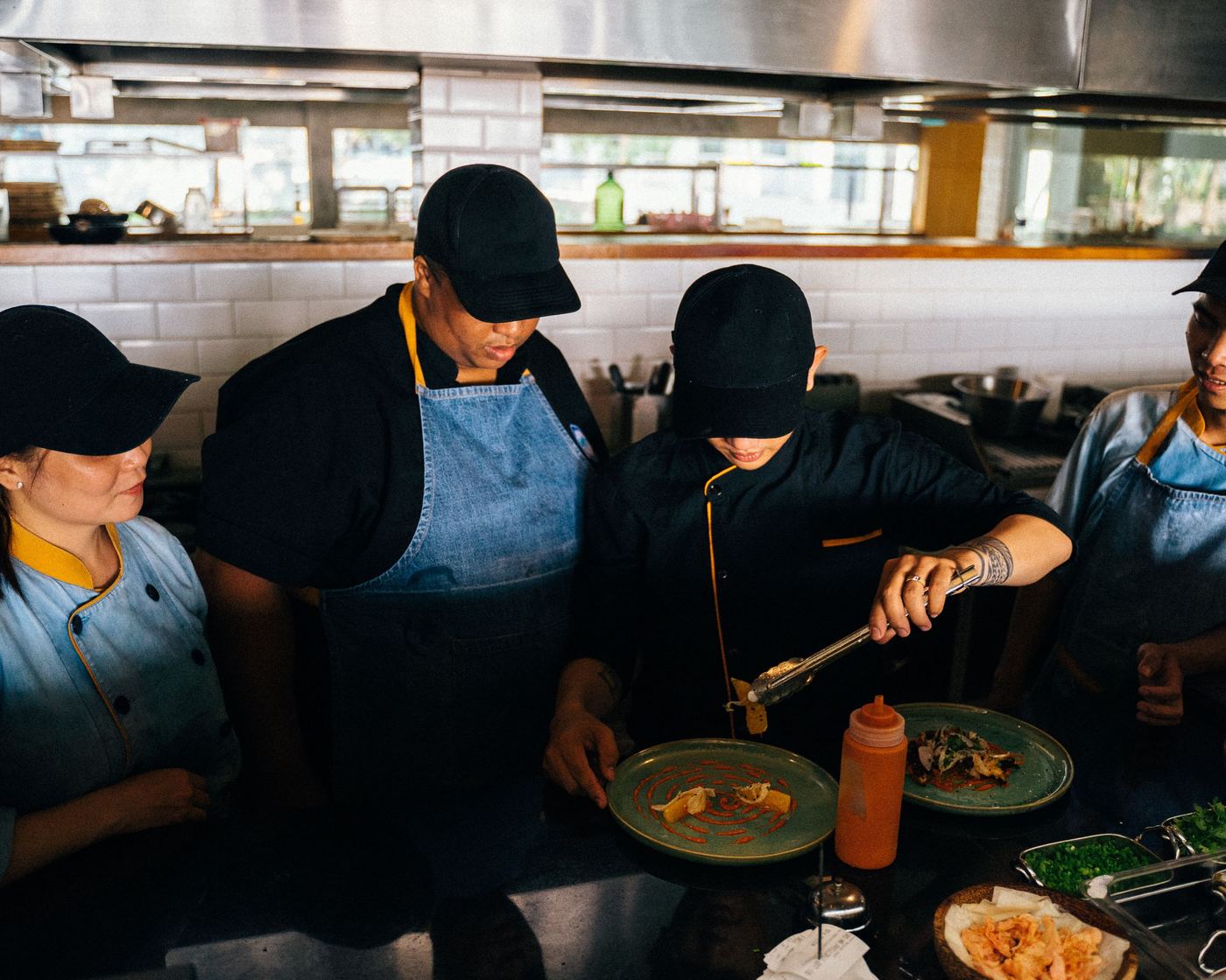 Kitchen team plating an order for a hotel restaurant